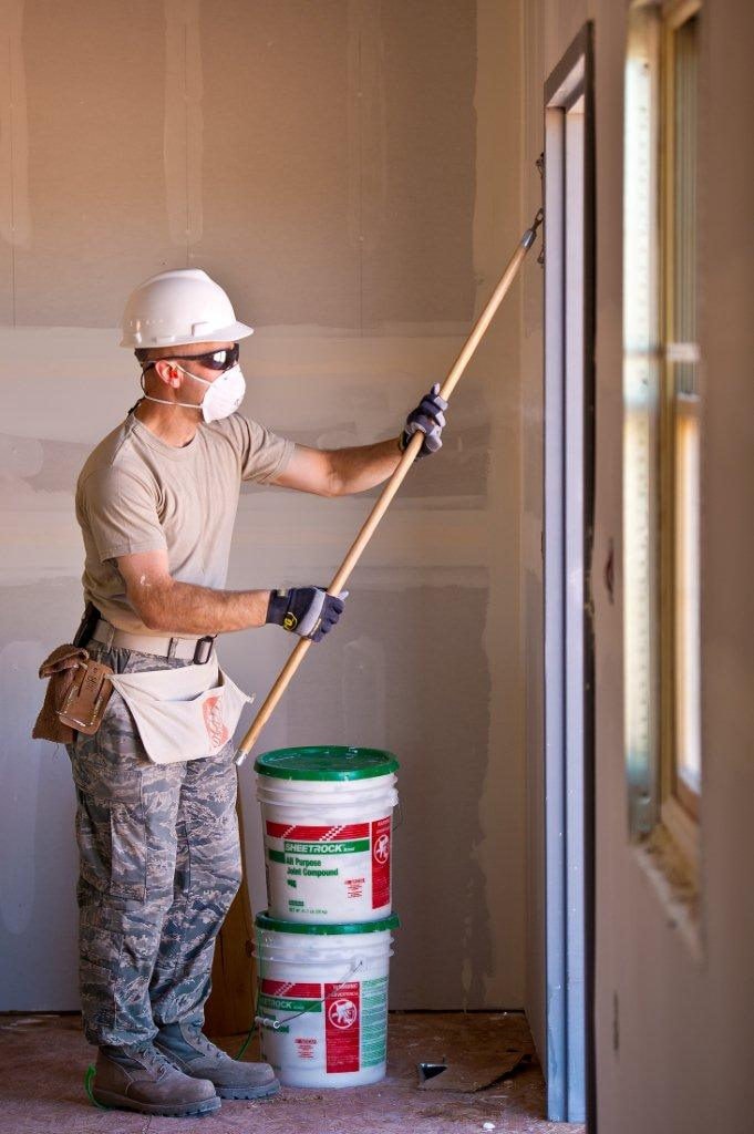 Drywall worker applying joint compound